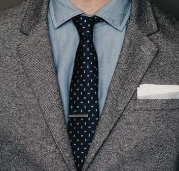 A person with coat, shirt and tie show how Tie Bar to help you dress better